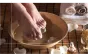 Feet resting on stones in a pedicure bath